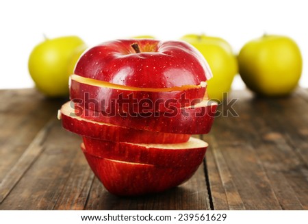 Cut apple on wooden table with other apples background