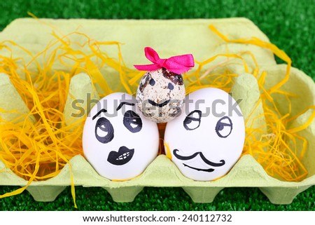 Eggs in egg tray on green background