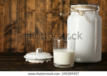 Open milk can on rustic wooden background