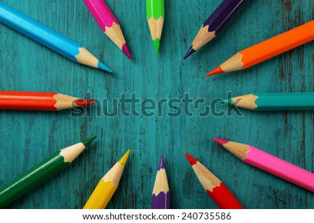 Colorful pencils on color wooden background