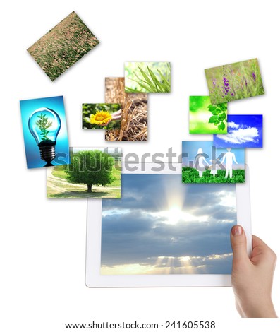 Tablet PC in hand and images of nature objects isolated on white