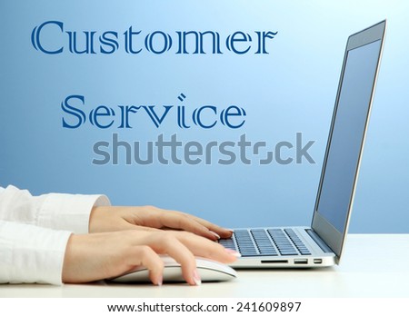 Female hands typing on laptop and Customer Service text on background