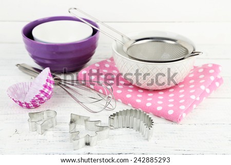 Kitchen utensils for baking on color wooden background