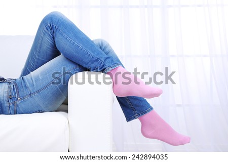 Female legs on sofa close-up