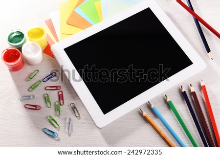 Tablet PC with watercolor on desktop background