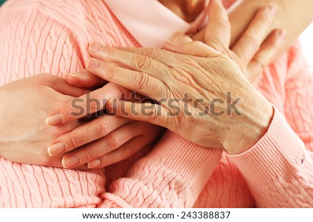 Old and young hands hug, closeup