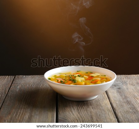 Delicious home cooked food with steam on table on brown background