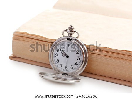 Silver pocket clock and book on white table