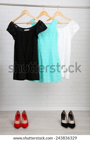 Female dresses on hangers in room