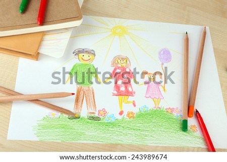 Drawing made by child with colorful pencils on wooden table background