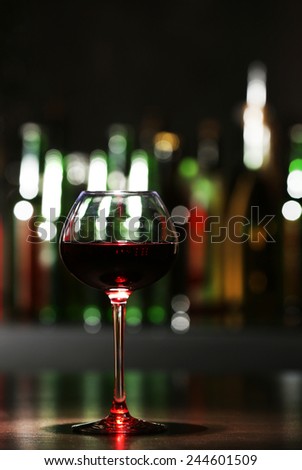 Glass of red wine in bar on blurred background