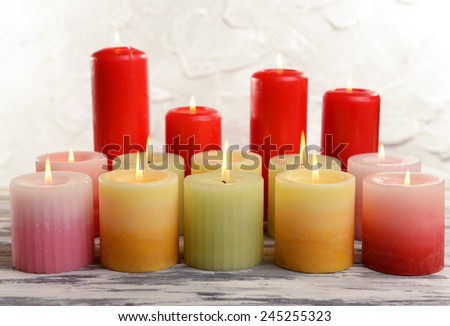 Beautiful candles on table on grey background