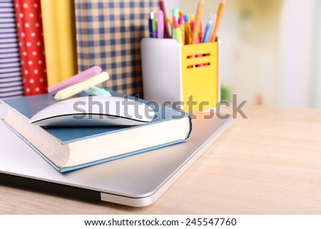 Books, computer mouse and pieces of chalk on wooden table and light background
