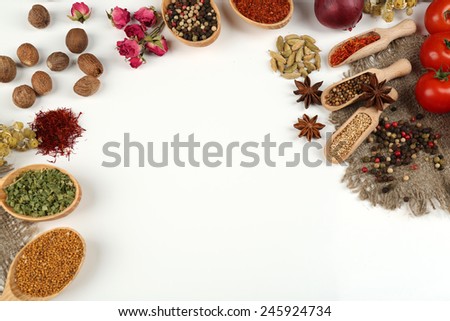 Different spices and herbs in wooden spoons isolated on white