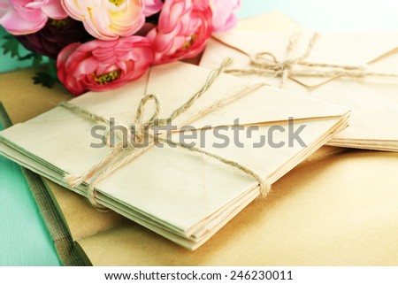 Old letters and book with flowers close up