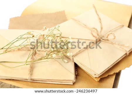 Old letters with dry flowers and book close up
