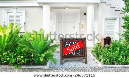 Sold home for sale Real estate sign in front of new house