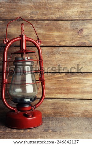 Kerosene lamp on wooden planks background