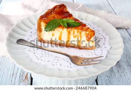 Cheese cake on paper napkin on plate on wooden background