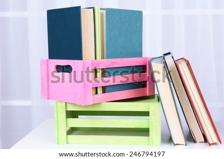 Many books in crates on light background