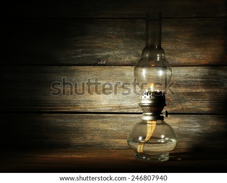 Kerosene lamp on rustic wooden planks background