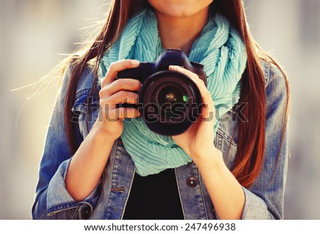 Young photographer taking photos outdoors