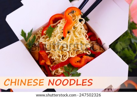 Chinese noodles with vegetables in takeaway box and space for your text