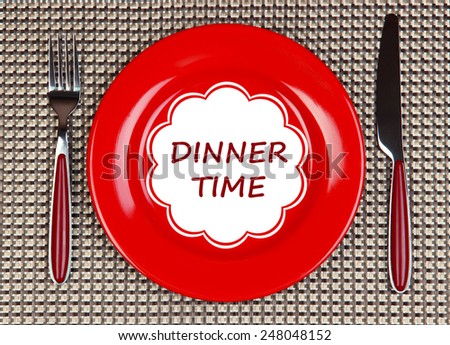 Plate with text Dinner Time, fork and knife on tablecloth background