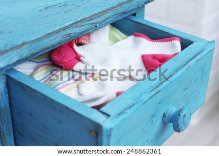 Socks in color drawer on white brick wall background