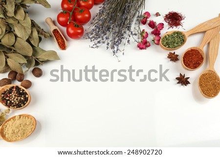 Different spices and herbs in wooden spoons isolated on white