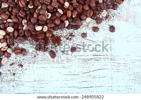 Coffee beans on light blue wooden background