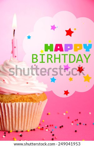 Tasty birthday cupcake with candle, on pink background