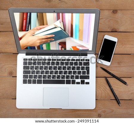 E-learning concept.  Digital library - books inside laptop