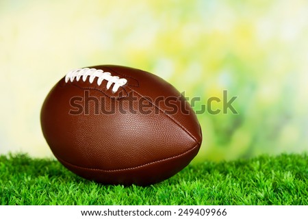 American football on field on green grass, on nature background