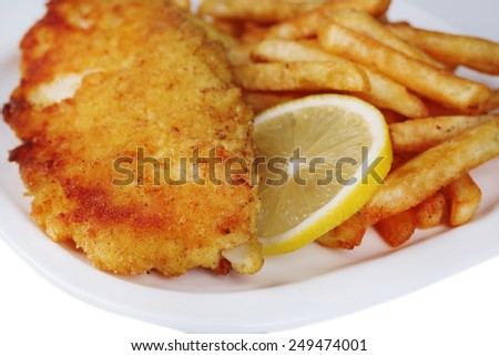 Breaded fried fish fillet and potatoes with sliced lemon on plate on white background