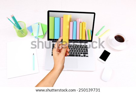 E-learning concept.  Digital library - books inside laptop