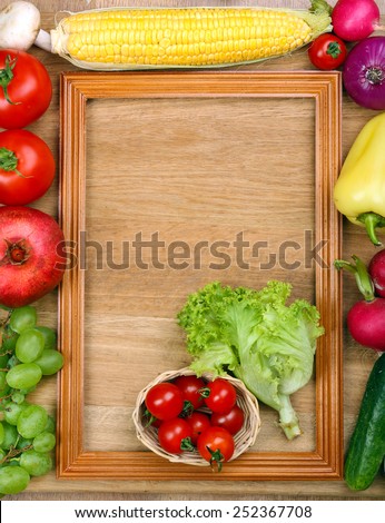 Summer frame with fresh organic vegetables and fruits on wooden background