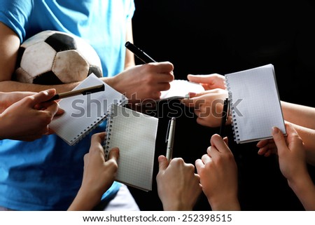 Autographs by football star on black and lights background