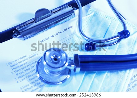 Medical history on clipboard with stethoscope on light background
