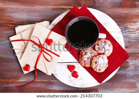 Love letters with coffee and cookies on wooden background