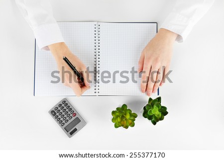 Hands working in the office with notebook, on white background