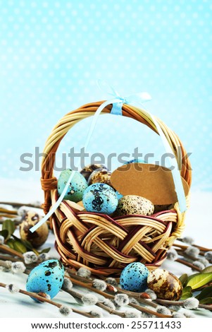 Bird eggs in wicker basket on bright background