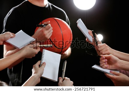 Autographs by basketball star on black and lights background