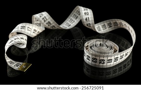 Measuring tape on black background