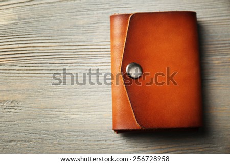 Hand made leather man wallet on wooden background