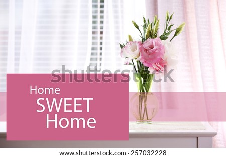 Beautiful flowers in vase with light from window and space for your text