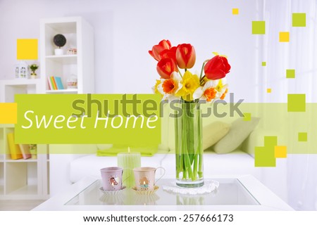 Fresh spring flowers in vase on home interior background and space for your text
