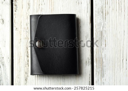 Hand made leather man wallet on white wooden background