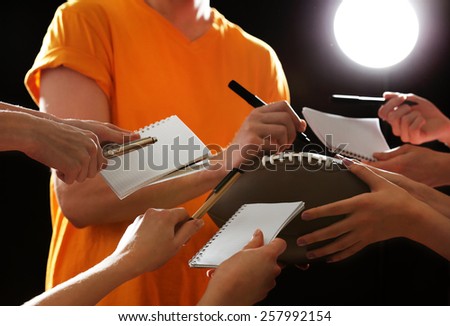 Autographs by American football star on black and lights background