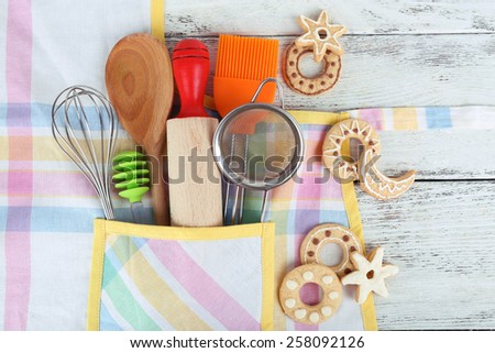 Set of kitchen utensils in pocket of apron, closeup